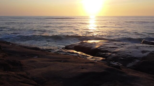 Waves Crashing on Cliff Rocks at Sunset near Windansea Beach which is a stretch of coastline in the La Jolla community of San Diego, California.