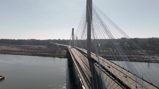 Traffic Flows Across the Port Mann Bridge Spanning the River in British Columbia, Canada - Orbit Drone Shot