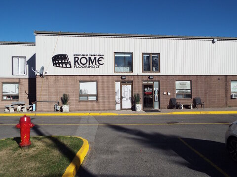 Nepean, Ontario, Canada &ndash; July 27, 2025: The "Rome Flooring LT" storefront features a Colosseum logo, "Where Great Floors Begin" slogan, tan siding, and a red hydrant at 58 Antares Dr #4.