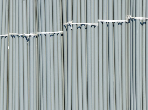 Aerial view of bundles of grey PVC pipes secured with white plastic ties at a construction site in New Taipei, New Taipei City, Taiwan.