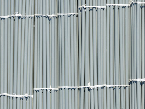 Aerial view of bundles of grey PVC pipes tied with white straps at a construction site in New Taipei, New Taipei City, Taiwan.