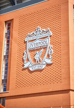 Liverpool, Uk, 01.01.2026. Liverpool Football Club crest mounted on a red brick stadium wall at Anfield, bold red and white colours glowing in bright daylight, creating a proud, iconic atmosphere