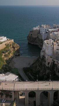 Aerial view of Polignano a Mare, panorama of the buildings the old town and Ponte Borbonico di Lama Monachile bridge, Puglia, Italy