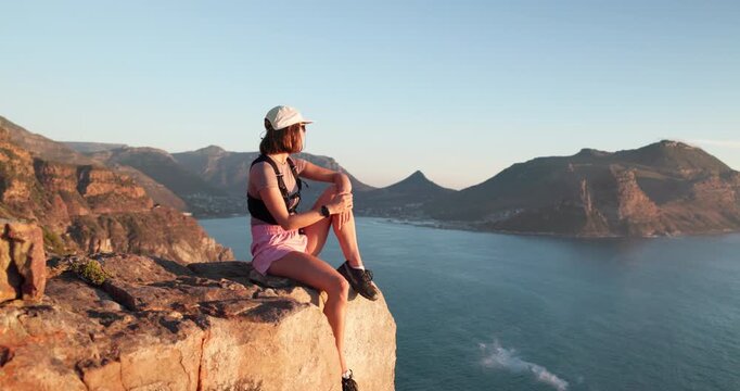 Hiking, thinking and woman with break on mountain peak, outdoor expedition rest and view ocean scenery. Reflection, and person relax on cliff for peace, trekking and daydream for holiday