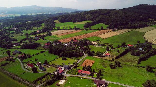Aerial Drone View of Rural Village in Lower Silesia in the morning, Rolling Hills and Late Summer Landscape