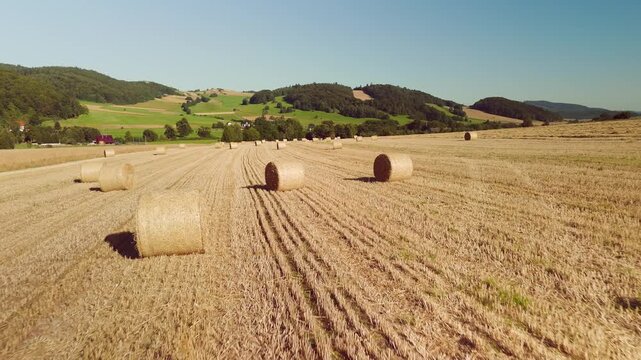 Aerial Drone View of Agricultural Fields with Farming Machinery in Mountainous Lower Silesia on a Sunny Day