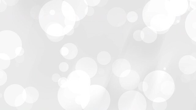 Bokeh effect featuring many white and light gray circles overlapping. Suitable for backgrounds, abstract concepts, design elements, and festive designs.