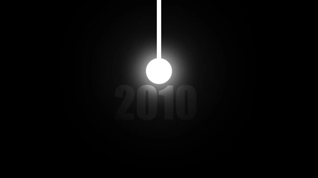 A glowing white sphere suspended by a thin white line against a dark black background with the year 2010 subtly displayed in gray text below the sphere creating a sense of motion or