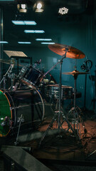Fototapeta premium Professional drum kit set up on stage with atmospheric lighting and smoke effects