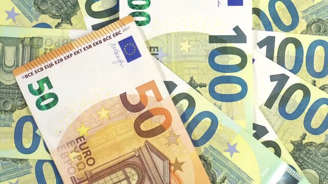 50 and 100 Euro Bills - Money circle spinning background
