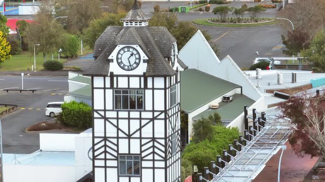 A clock tower with black and white timber framing stands prominently in a suburban area. A commercial or institutional setting in Stratford, Taranaki, New Zealand.