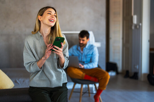 Woman enjoys digital lifestyle at home, using smartphone for online connection, mobile communication
