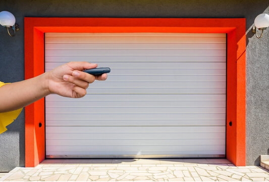 Garage door PVC. Hand use remote controller for closing and opening garage door
