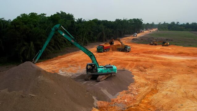 Malaysia, Selangor - April 10, 2023 Construction machinery aerial view of foundation site progress.