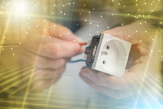 Electrician connecting a wire into a power socket; multiple exposure