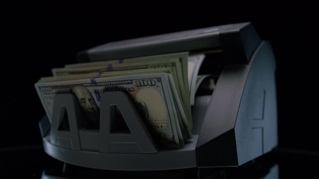 Money counting machine with stacked dollar bills