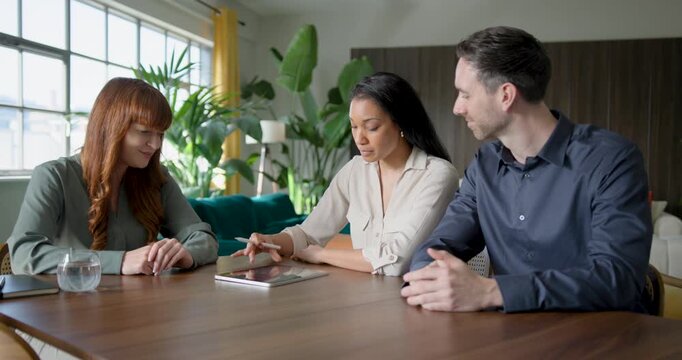 Financial advisor meeting with a couple to discuss finances