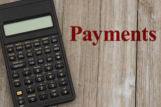 Payments message with calculator on wood desk