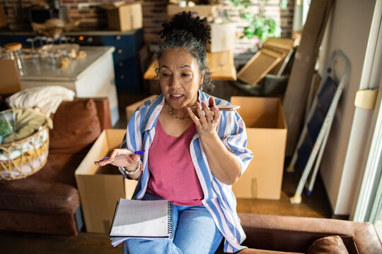 Senior woman planning a home move on phone at home