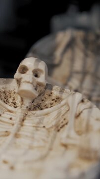 Halloween skulls and skeletons close up ashtrays with skeletons ceramic figurines on store shelves