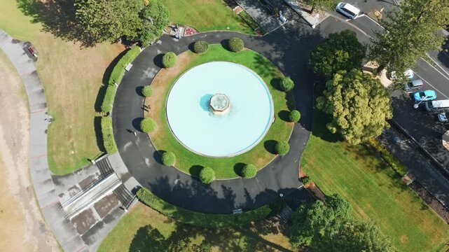 Aerial view of a circular fountain with manicured bushes and a paved walkway in a park in Marine Parade, Napier, Hawkes Bay, New Zealand.