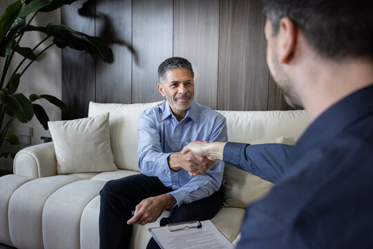 Business meeting with handshake in modern setting