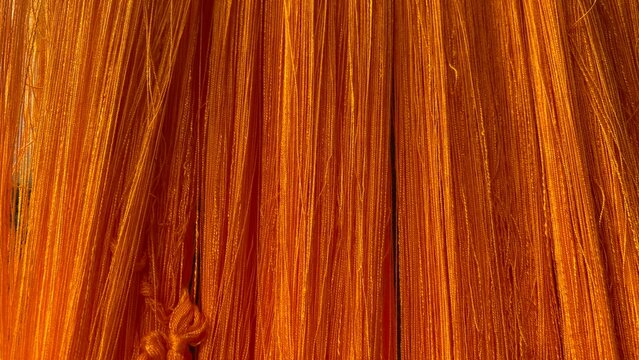 Traditional Silk or Cotton Thread Drying Process with Vibrant Orange Color
