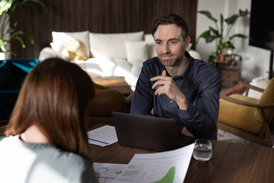 Casual business meeting with papers and a laptop