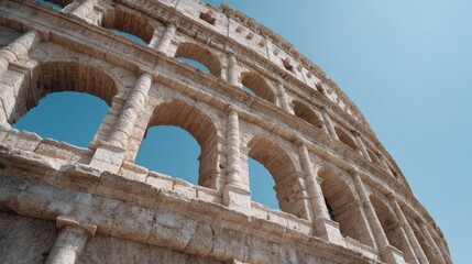 Obraz premium Stunning View of Old Roman Coliseum Ruins Against a Clear Blue Sky Capturing the Grandeur of Ancient Architecture and Historical Significance