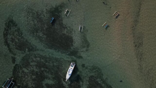 Sanur Beach (Bali) top down view from drone - Boats, beach, ocean, pier