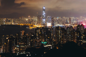 Fototapeta premium Hong Kong night evening view, China, seen from Victoria Peak observation deck, Lugard road lookout, with Hong Kong downtown skyscrapers and Kowloon island, illuminated city and Victoria Bay at night