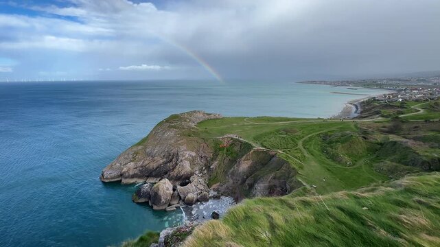 Little Orme Cliffs and Angel Bay with Rainbow over the Irish Sea, Llandudno, Conwy, Wales, UK