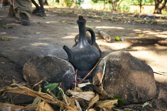 Traditional Ethiopian coffee pot Jebena on an open fire outdoors
