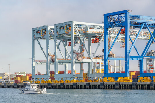 Boston, MA, US-March 29, 2026: Large loading cranes in Boston Harbor used to load shipping containers onto ships.