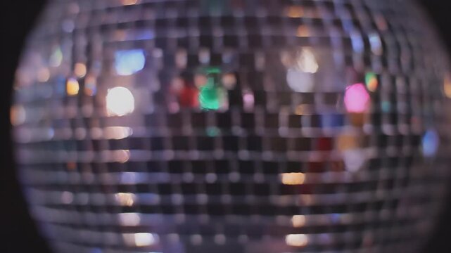 Disco ball reflections swirl with colorful lights.