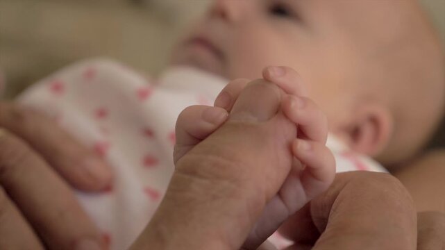 B&eacute;b&eacute; donnant la main &agrave; un doigt
