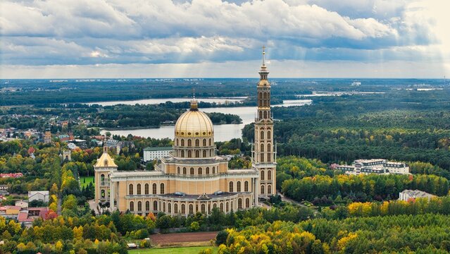 Drone panorama of Licheń Stary with Basilica of Our Lady of Licheń, lakes and rural landscape, Poland