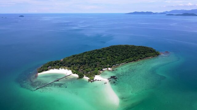 Discover the stunning beauty of Koh Kham in Trat, Thailand, as turquoise waters gently caress white sandy beaches.