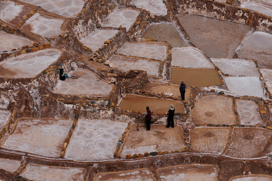 workmen in incan salt terraces