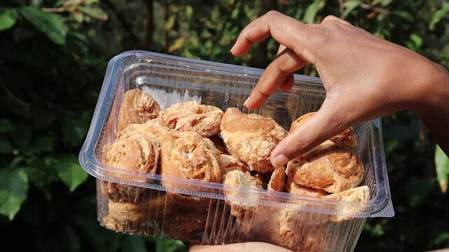 Box full of baked biscuit type of snack that is consumed with coffee or tea