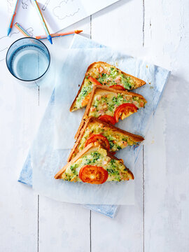 This image showcases vegetable toast topped with fresh tomatoes and cheese, presented on a light background. It is ideal for promoting breakfast menus, meal prep ideas, and healthy eating concepts