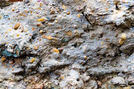 Textura de roca sedimentaria que muestra guijarros incrustados, diversidad mineral, procesos de formaci&oacute;n natural y estructura geol&oacute;gica detallada. Primer plano de la superficie de una roca sedimental