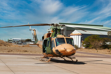 Fototapeta premium Military transport helicopter with desert camouflage parked on a tarmac