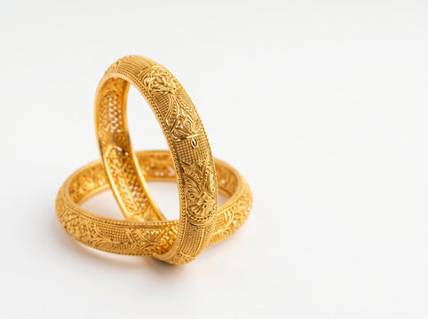 indian gold bangles on white background representing gold loan finance investment and wealth security concept