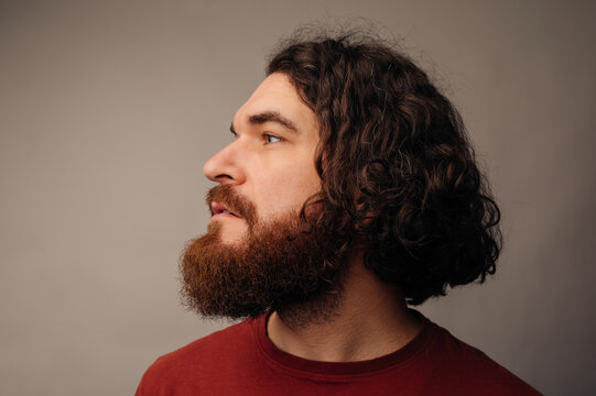 Pensive Bearded Man Side Profile Gazing Upward, Contemplative Expression, Soft Studio Light, Curly Hair