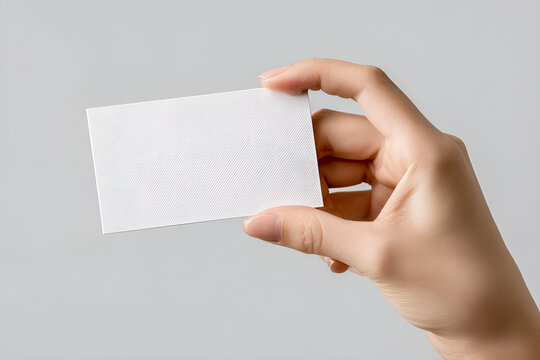 Hand holding blank white business card mockup