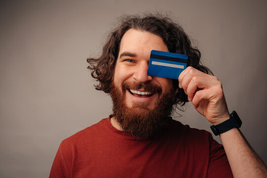 Man Holding Credit Card With Excited Grin, Closeup Portrait, Fintech And Payment Concept, Secure Vibe