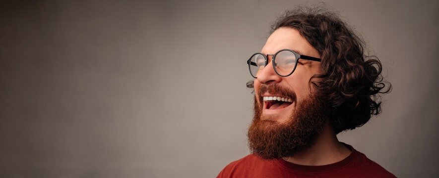 Man Laughing Heartily In Candid Closeup, Glasses And Beard Highlight Expressive Joy, Studio Lighting Captures