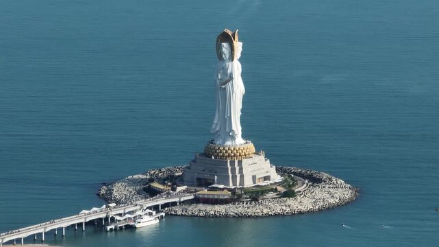 Aerial footage of Guanyin statue at seaside in nanshan temple, hainan island , China. Words mean mercy and blessing.