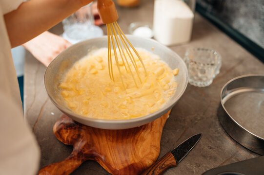 Whisking Creamy Batter In Stainless Bowl, Energetic Motion Captured With Wooden Cutting Board And Knife